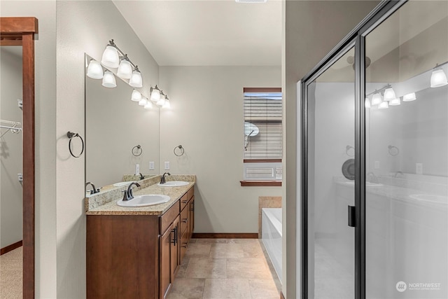 bathroom with tile patterned flooring, vanity, and shower with separate bathtub