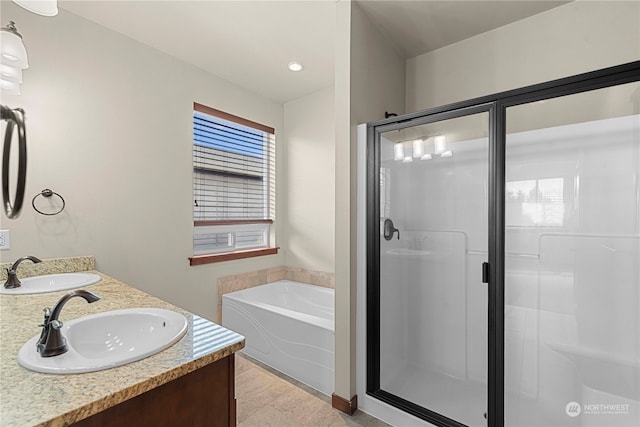 bathroom with vanity and independent shower and bath