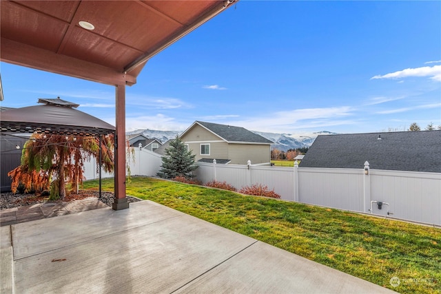 view of patio featuring a gazebo and a mountain view