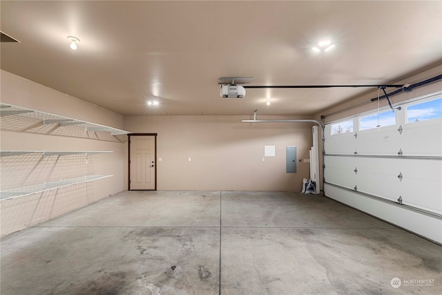 garage with electric panel and a garage door opener