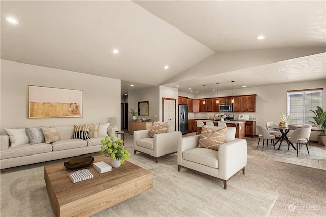 living room with light colored carpet and vaulted ceiling