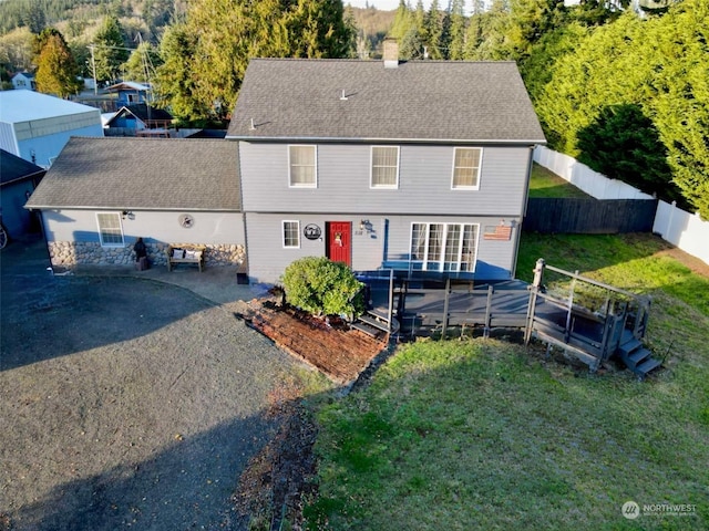 view of front of property with a patio, a deck, and a front lawn