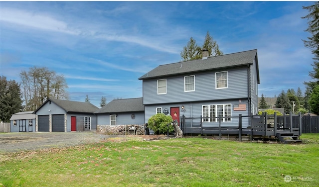 view of front of home featuring a shed, a front yard, and a deck