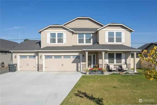 view of front of house featuring a front lawn and a garage