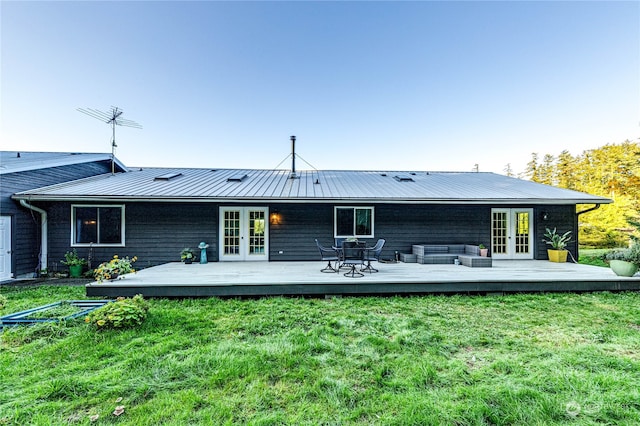 back of house with a wooden deck, french doors, and a yard