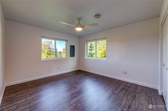 empty room featuring dark wood-type flooring and ceiling fan