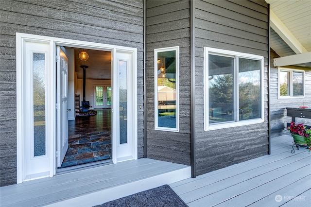 view of exterior entry with a wooden deck