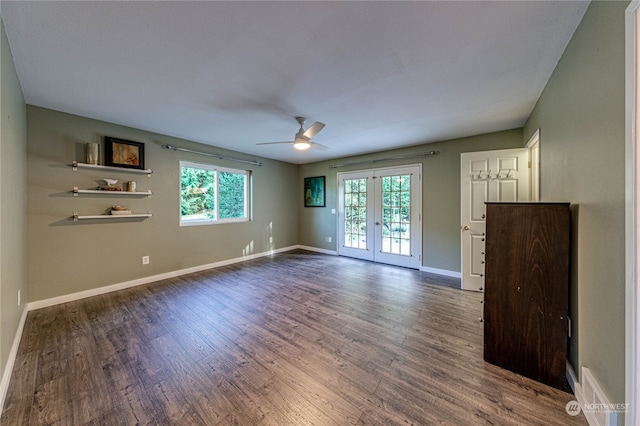 empty room featuring dark hardwood / wood-style flooring, french doors, and a wealth of natural light