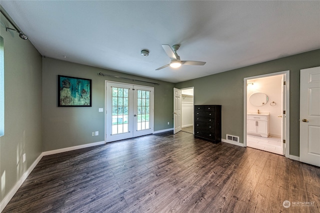 unfurnished bedroom with ceiling fan, dark hardwood / wood-style flooring, access to exterior, french doors, and ensuite bath