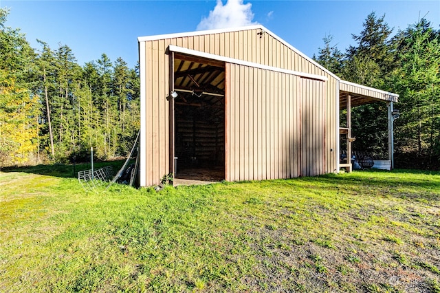 view of outbuilding with a yard