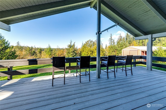 wooden deck with a storage shed