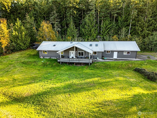 exterior space with a front yard and a wooden deck