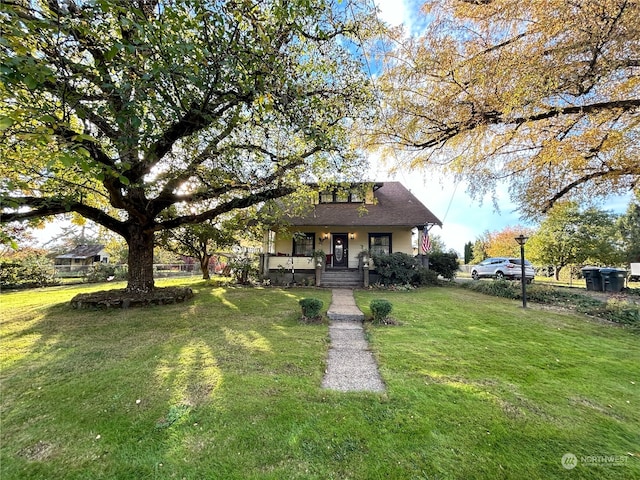 bungalow-style home featuring a front lawn