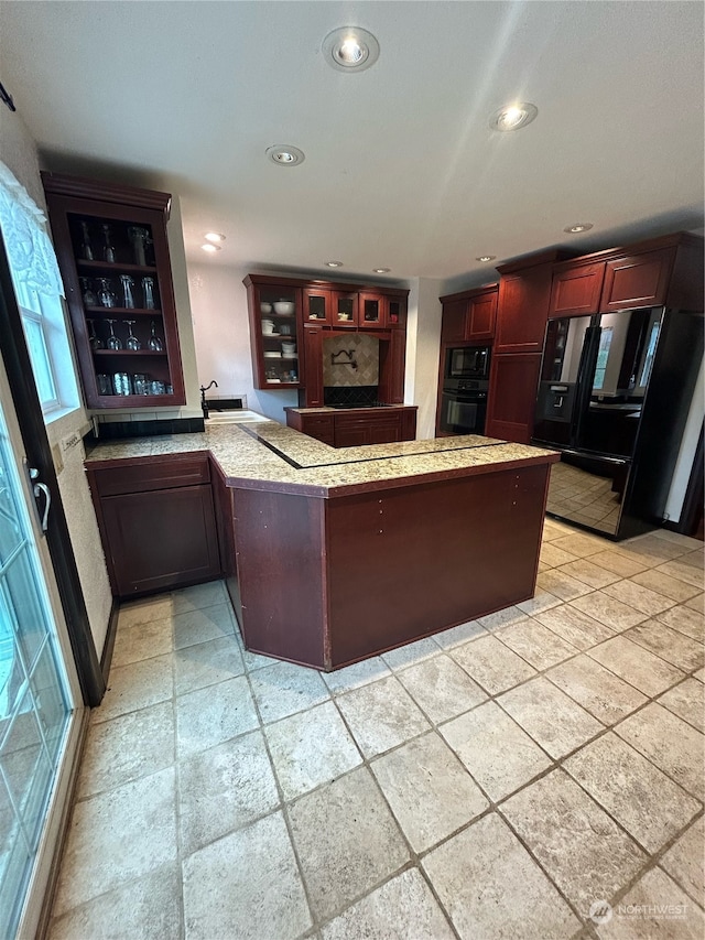 interior space featuring black appliances and kitchen peninsula