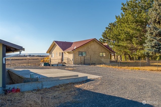 exterior space featuring a rural view and a patio