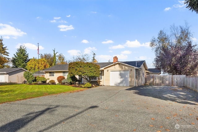 ranch-style house with a front yard and a garage