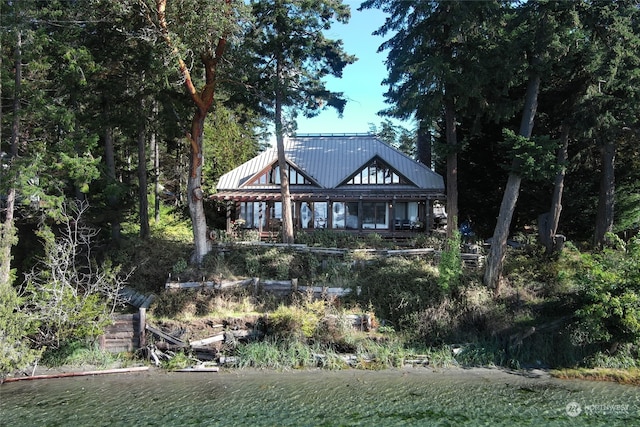 rear view of property featuring a water view