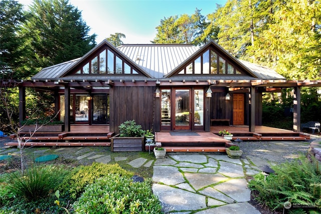 back of property featuring a wooden deck and french doors