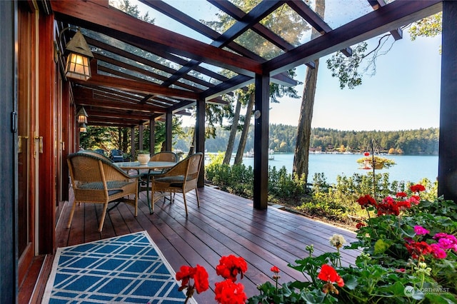 308 De Haro Ln, San Juan Island, WA 98250 - wooden deck with outdoor dining area, a water view, a view of trees, and a pergola