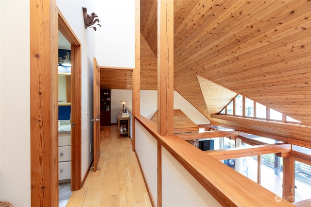 hall featuring wood ceiling, lofted ceiling, and light hardwood / wood-style flooring