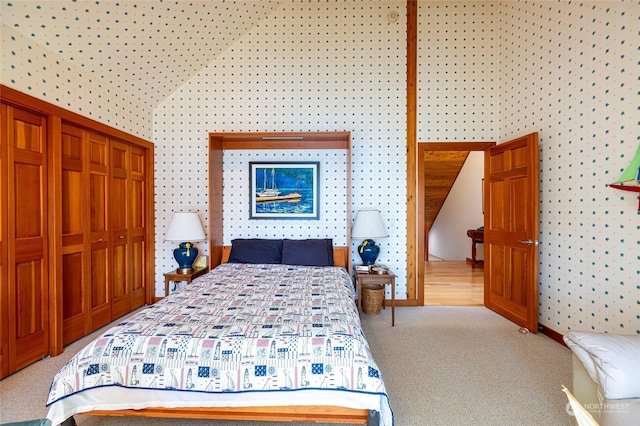 308 De Haro Ln, San Juan Island, WA 98250 - bedroom with baseboards, high vaulted ceiling, a closet, light carpet, and wallpapered walls