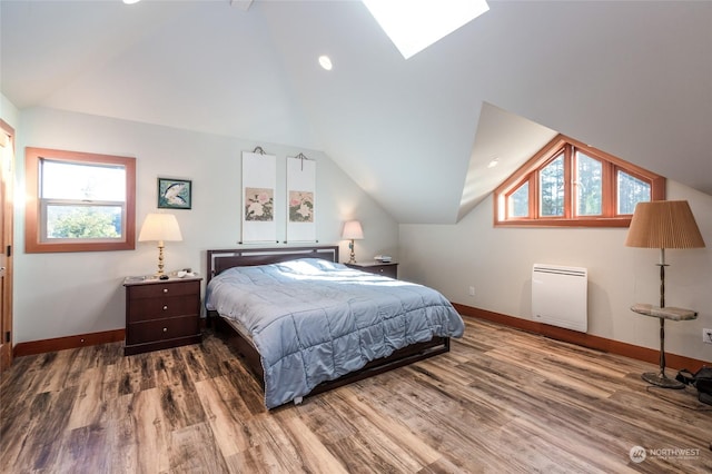 308 De Haro Ln, San Juan Island, WA 98250 - bedroom with vaulted ceiling with skylight, baseboards, and wood finished floors