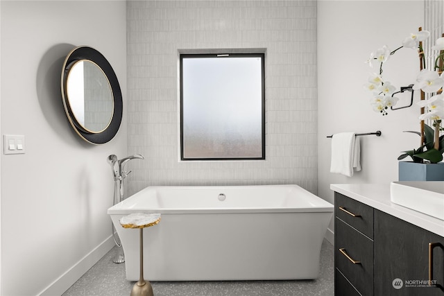 bathroom featuring a bathing tub, vanity, and tile walls