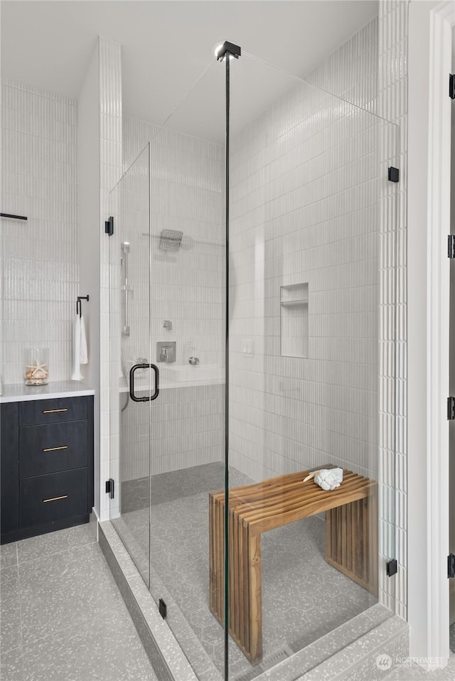 bathroom with tile walls and walk in shower