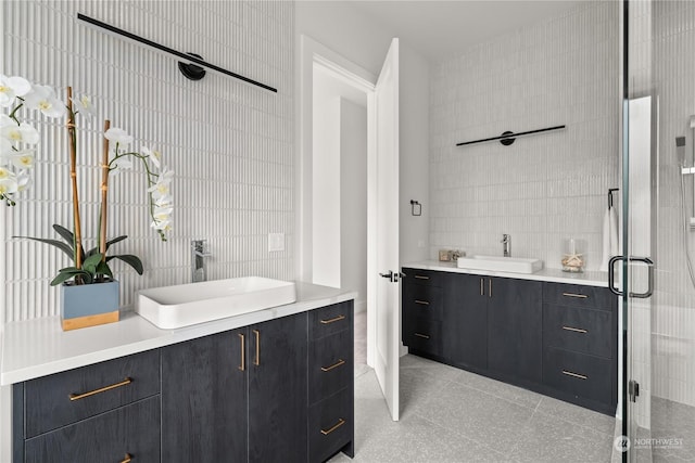 bathroom featuring vanity, tile walls, and a shower with shower door