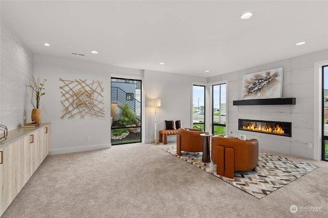 carpeted living room with a tiled fireplace