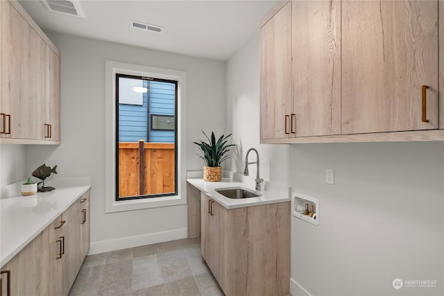 laundry room featuring cabinets, sink, and hookup for a washing machine