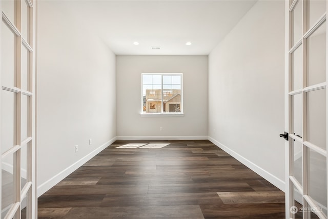 spare room with dark wood-type flooring