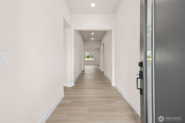 hall with light wood finished floors, recessed lighting, and baseboards