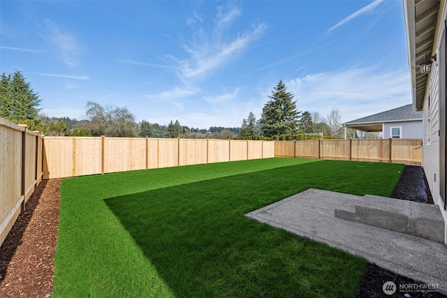 view of yard with a fenced backyard