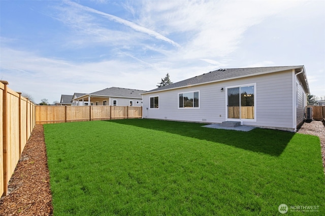 back of property featuring a yard and a fenced backyard