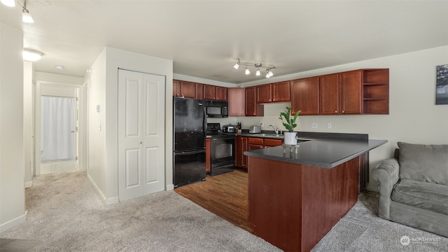 kitchen with black appliances, light colored carpet, kitchen peninsula, and sink