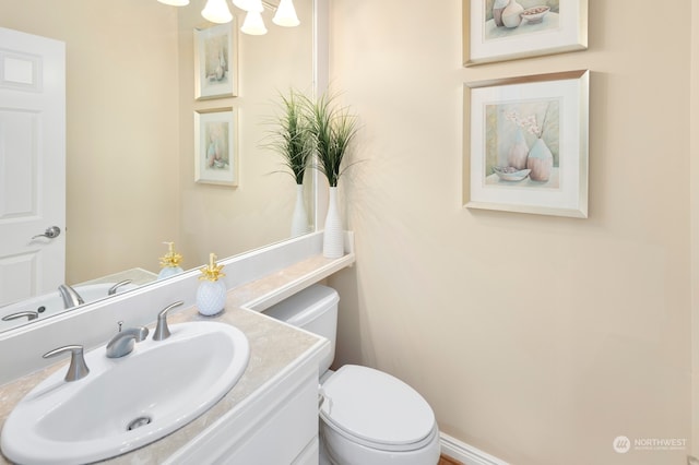 bathroom with toilet and vanity