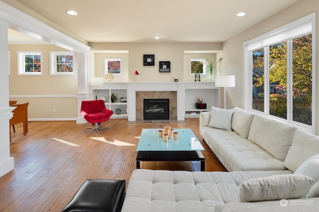 living room with light wood-type flooring and a fireplace