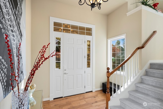 foyer entrance featuring a notable chandelier and light hardwood / wood-style flooring