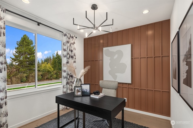 office featuring hardwood / wood-style flooring, an inviting chandelier, and plenty of natural light