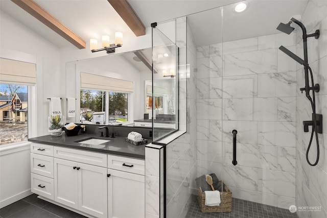 bathroom with vanity, tile patterned floors, a shower with shower door, and lofted ceiling