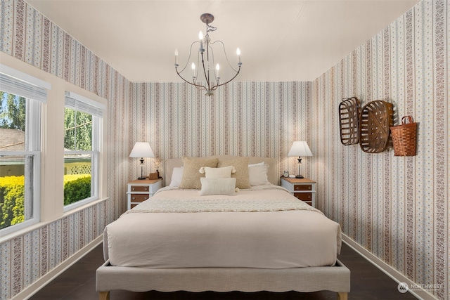 bedroom featuring a chandelier and dark hardwood / wood-style floors