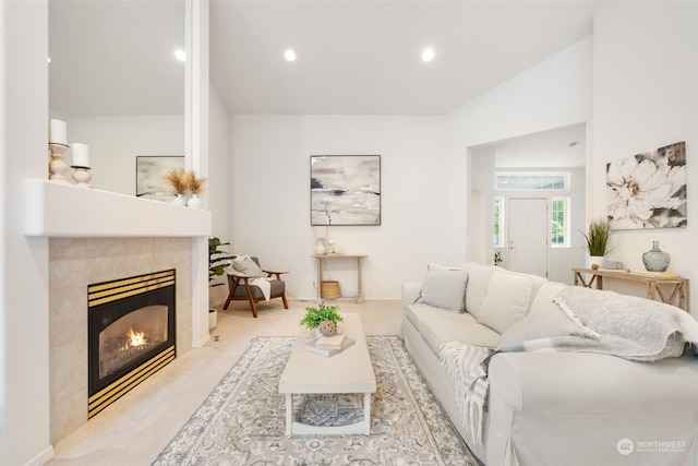 living room featuring lofted ceiling and a fireplace