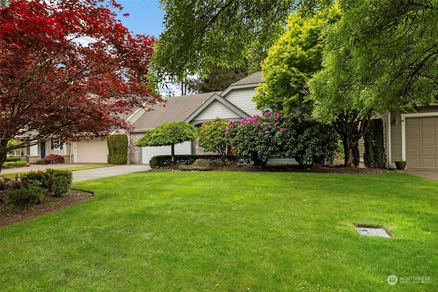 obstructed view of property featuring a garage and a front lawn