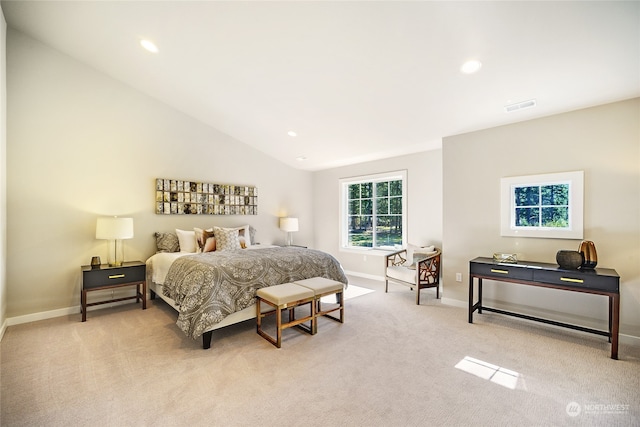 bedroom featuring light colored carpet and vaulted ceiling