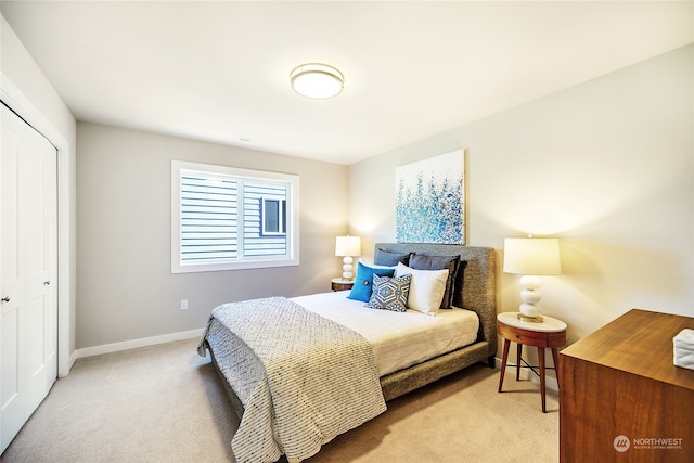 bedroom with a closet and light colored carpet