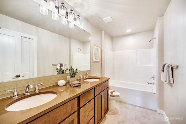 full bathroom featuring backsplash, shower / washtub combination, vanity, and toilet