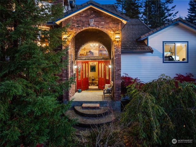 view of exterior entry featuring a patio