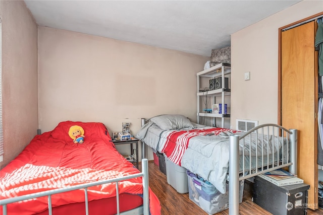 bedroom with dark hardwood / wood-style flooring