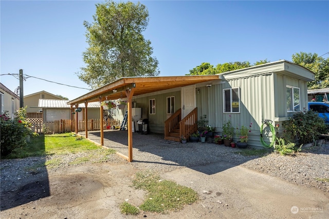 back of house with a carport